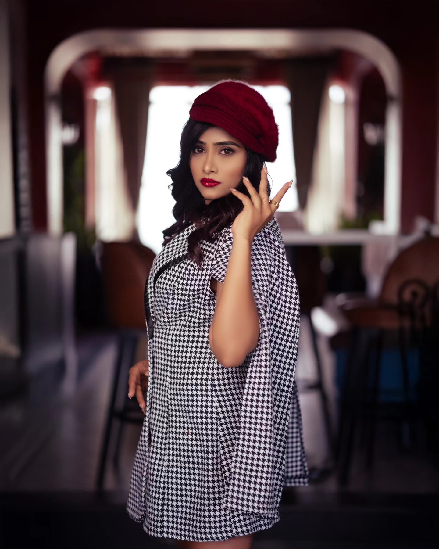 Chic black and white check attire styled against a vintage auto rickshaw background